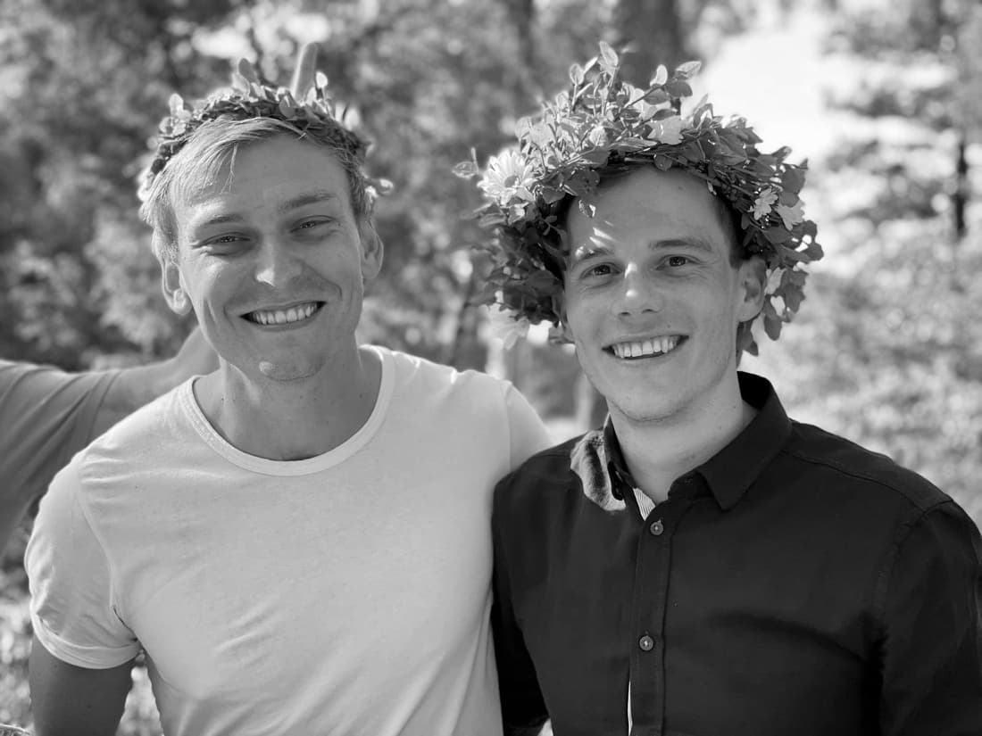 Gustaf and Magnus wearing midsummer flower crowns